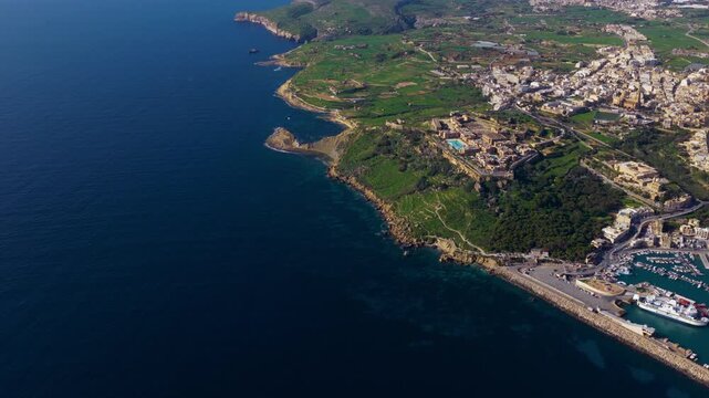Panoramic View Of A Coastal Resort Town In Mgarr On The Island Of Gozo In Malta. Aerial Drone Shot 