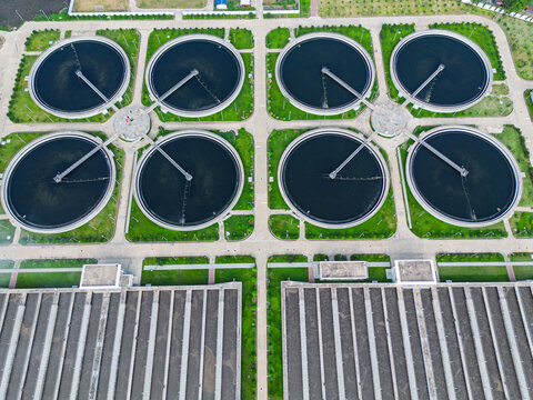 Aerial view of the Sewage Treatment Plant, Dhaka WASA featuring circular clarifier tanks with rotating arms and green lawns in Dhaka, Dhaka Division, Bangladesh.