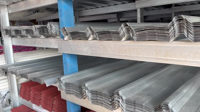 Galvanized steel roof panels piled on shelves close up