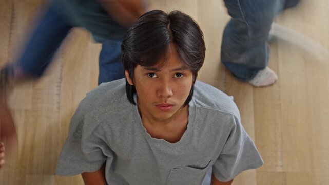 Portrait of lonely youth feeling disconnected from society while others rush past