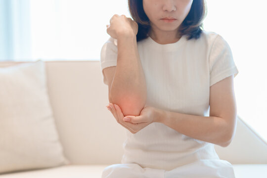 Woman having elbow ache for concepts of Tennis Elbow, muscle pain, lateral epicondylitis, Bursitis, injury, Office syndrome. Health care and medical Health concept
