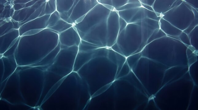 Abstract blue water texture with light caustics creating dynamic reflective patterns on surface