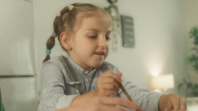 Child learning and practicing educational activity at home with support from parent in comfortable indoor environment.