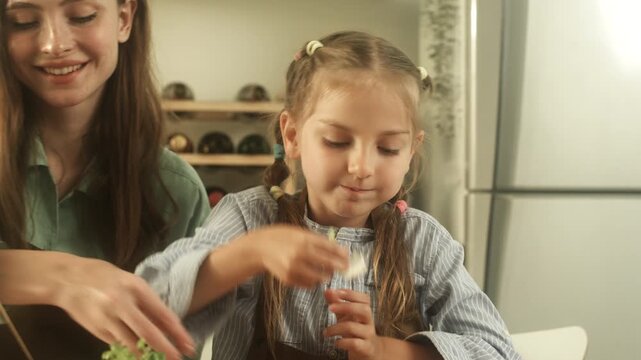 Child learning and practicing educational activity at home with support from parent in comfortable indoor environment.