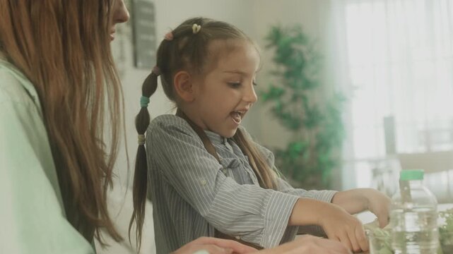 Child learning and practicing educational activity at home with support from parent in comfortable indoor environment.