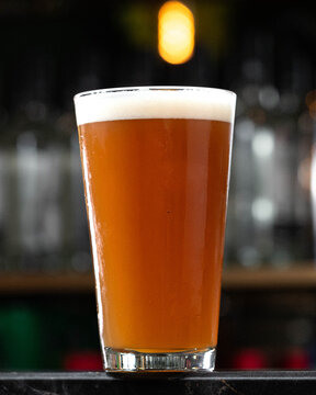 Golden beer fills a pint glass