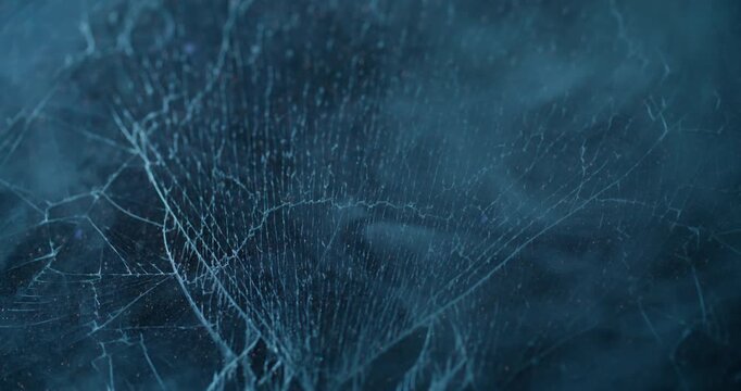 Blue fume. Broken window. Defocused color smoke vapor cold fragile texture smog mist scratched glass on abstract uneven background.