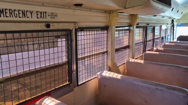 Inside view of emergency exit window in a prison bus Blue Bird of M.S.D.O.J. with bars on the windows