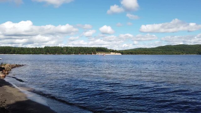 Panning timelapse shot during a warm summer day on Lac Simon, a beautiful recreational lake in Duhamel, Quebec, Canada.