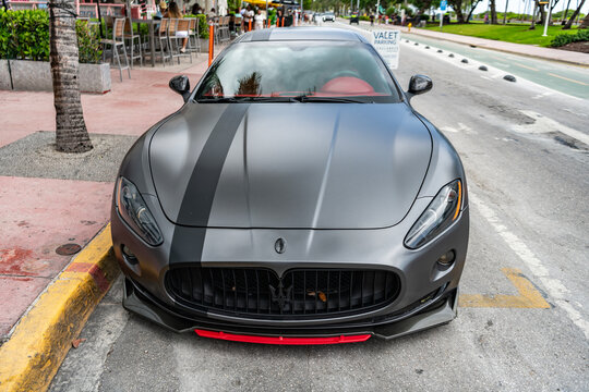 Miami, Florida, USA - July 27, 2025: Luxury gran Turismo car Maserati. Car coupe Maserati parked outdoor. Black matte car, front view. Maserati Gran Turismo 2015 coupe car.