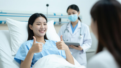 Fototapeta premium Recovery with Encouragement: A patient radiates optimism, offering a double thumbs-up while reclining in a hospital bed, a symbol of hope and recovery under the watchful care of medical professionals.