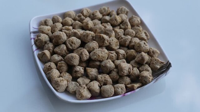 Dry soya chunks served on a white square ceramic plate