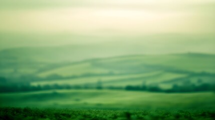 Fototapeta premium Soft focus green rolling hills under a pale sky landscape