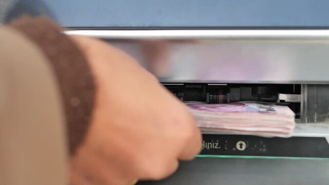 turkish lira Cash withdrawal at an ATM machine in a city area