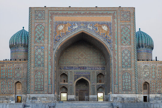 Sher-Dor Madrasah facade at Registan Square in Samarkand with turquoise domes and intricate tilework. Ideal for travel, heritage, and architecture publications.