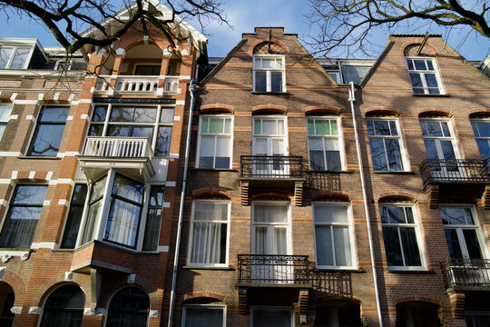 Beautiful sunlight and shadows on the historic brick facades of traditional houses in Amsterdam