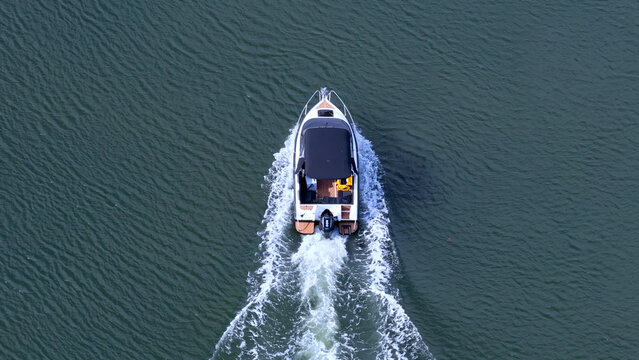 Top Down Aerial View of a Speedboat Cruising on Calm Water