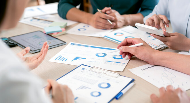 Collaborative Business Team Analyzing Financial Growth and Sales Reports