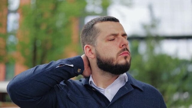 Bearded man outdoors feeling neck pain. Discomfort visible, massaging and stretching to find relief. Expressions shift from strain to temporary comfort, then back to worried face.