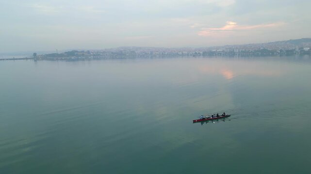 Sunrise Water With Rowing Crew Gliding In Long Shell, Eight Athletes Executing Precise Strokes Under Pastel