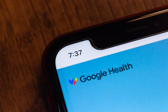 Mexico City, MEXICO - May 11 2026 : Close-up of a smartphone on a wooden surface displaying the Google Health logo from its official website.
