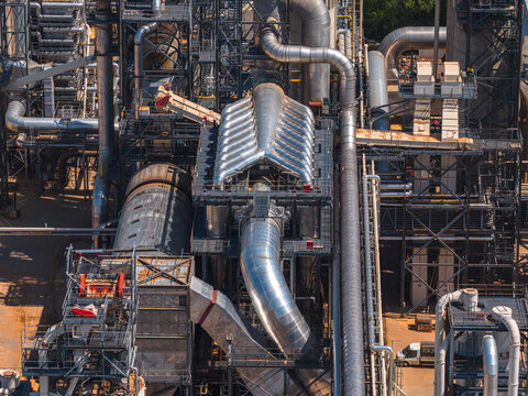 Aerial view of the complex network of industrial pipes, metal structures, and machinery at a factory in Jihlava, Vysocina Region, Czechia.