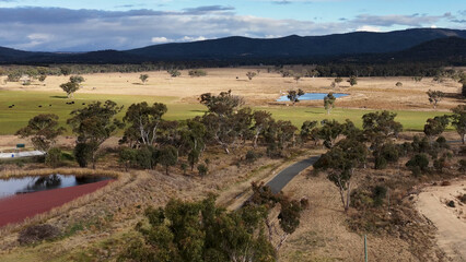 Naklejka premium Aerial View of Rural Queensland Landscape with Ponds and Winding Road