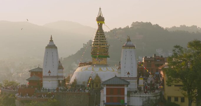 Aerial view of Swayambhu temple stupa, a monument in Kathmandu, Nepal, with heritage architecture, valley landscape and golden hour light at the UNESCO heritage site.
