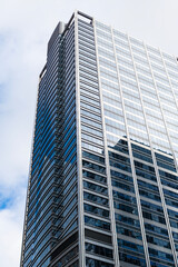 Fototapeta premium Glass building. Business city. City architecture. Modern glass building. Reflective glass architecture. Architecture in business district. Building architecture. Business building. Commercial zone