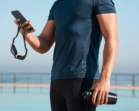 Hands, swimmer and man with cellphone outdoor for texting, networking or contact at practice. Typing, fitness and male athlete with phone for social media on mobile app at competition training.