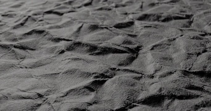 Crumpled Texture with Linear Motion. Video showing dynamic movement over a dark rough texture with crumpled details.