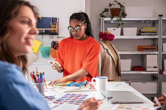Multiethnic women working in sewing atelier and studio