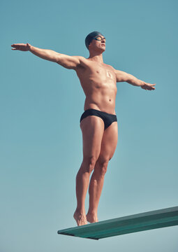 Sports, ready and man with diving board for wellness, exercise and training on blue background. Stretching, fitness and athlete or swimmer person for competition, event and confident for jump
