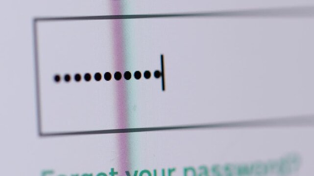 4K macro shot of a password field with placeholder text being filled with hidden dots during a login or signup process.