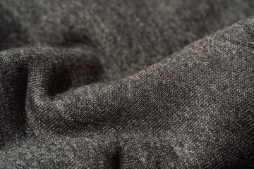 Gray knit fabric with soft folds in close up. © Anastassiya 