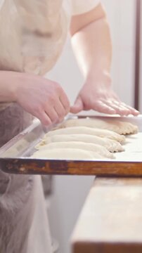 Cook puts pies on the tray for baking
