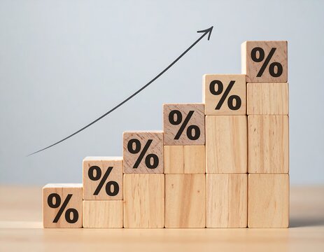 Five wooden blocks arranged as a rising staircase with percentage symbols and a black arrow pointing upwards to represent financial growth and interest rate hike