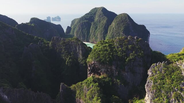Aerial: Ko Phi Phi Le, island of the Phi Phi Archipelago during the day in the Andaman Sea, Krabi province, Thailand, crane up drone shot