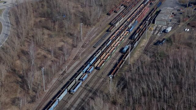 Aerial view of a busy motorway passing over railway lines with freight wagons in Ostrava, highlighting transport infrastructure, logistics, and industrial connectivity.