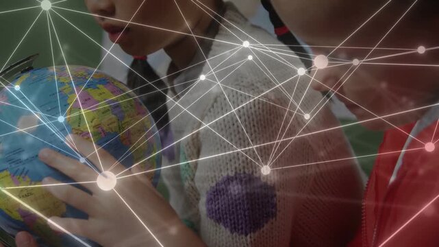 Two girls leaning in placing hand, rotating globe for education while nodes drifting over hands