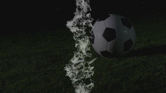 Particle column appearing from ground, rising and reshaping to reveal soccer ball as shadow passing