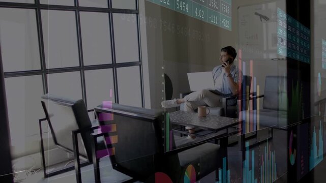 Man picking up phone for work call in lounge, animated business charts shifting over laptop