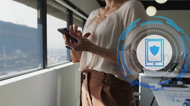 Mid-adult woman holding phone by window, tapping screen causing security HUD growth, securing data
