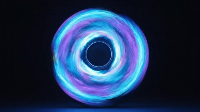 Mesmerizing glowing fidget spinner spinning against a dark background with blue and purple light trail