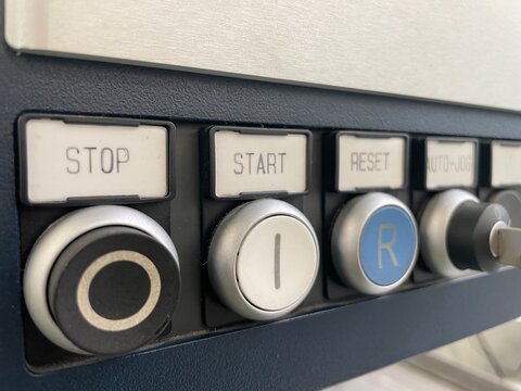 Machine Control Panel: A detailed shot of an industrial control panel featuring button interfaces and textual labels, designed for operational procedures and industrial design.
