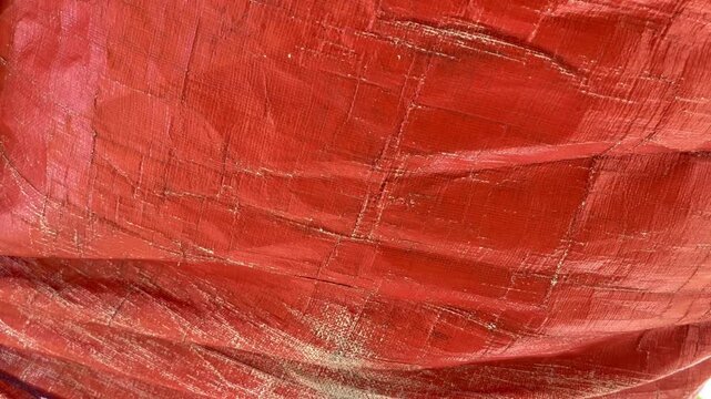 Orange plastic tarp texture background with woven pattern
