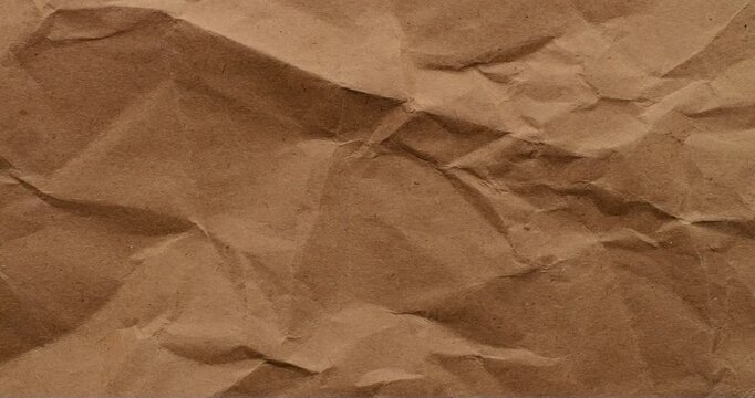 Stop-Motion Crumpled Kraft Paper Texture. Rapid stop-motion animation quick successive changes of wrinkled brown kraft paper osurfaces.