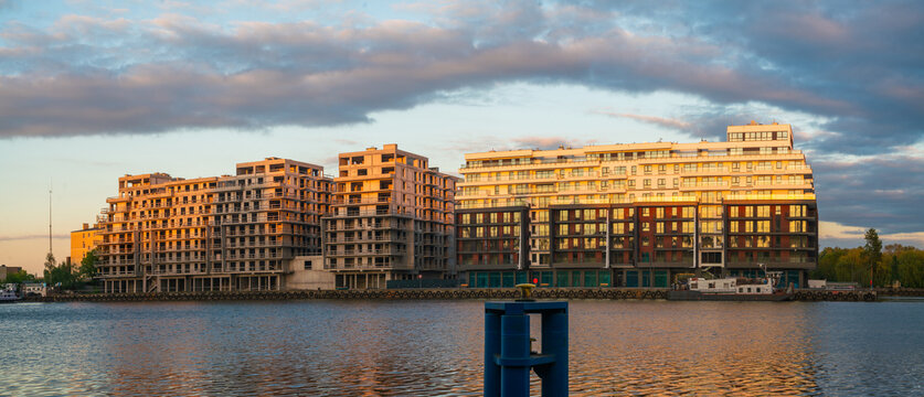 A modern housing estate of multi-story residential buildings by the river