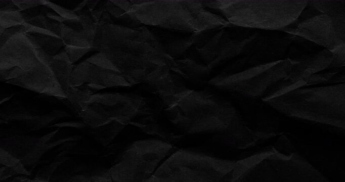 Stop-Motion Crumpled Black Paper Texture. Stop-motion animation quick successive changes of wrinkled paper osurfaces, creating dynamic textured transitions with visible creases.