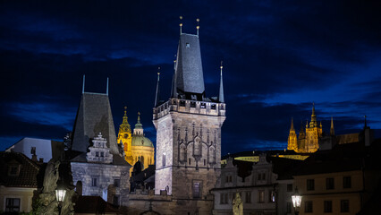 Obraz premium Charles Bridge Lesser Town Towers And Castle At Night Against Dark Blue Sky, Prague, Czech Republic